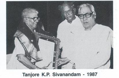 Emani Sankara Sastry conferring the title “ Sangeetha Choodamani” on Tanjore K.P.Sivanandam in the year 1987.R.Yagnaraman look on.